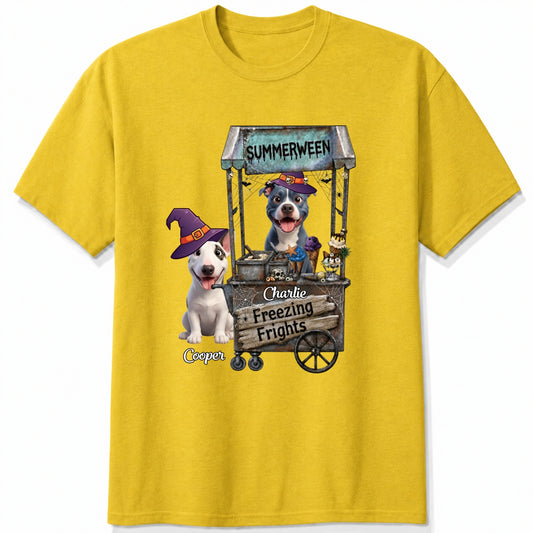 A yellow custom t-shirt featuring a graphic print of dogs dressed as witches behind a wooden ice cream cart labeled 'Summerween' and 'Freezing Frights'.
