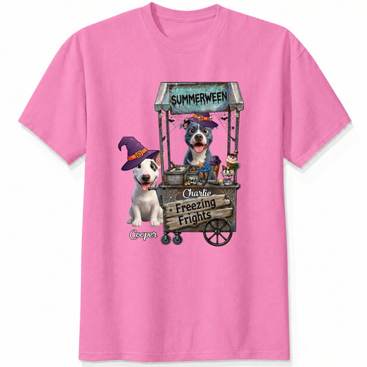 A pink custom t-shirt featuring a graphic print of dogs dressed as witches behind a wooden ice cream cart labeled 'Summerween' and 'Freezing Frights'.