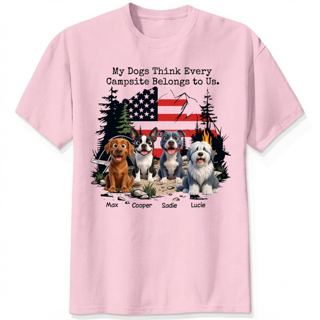 A pink short-sleeve t-shirt featuring a graphic print of dogs sitting in front of a campfire and an American flag, with the text 'My Dogs Think Every Campsite Belongs to Us.' and custom with dog's names below.