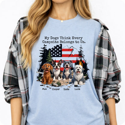 A woman wearing a blue graphic t-shirt with a dog camping scene and the text 'My Dog Thinks Every Campsite Belongs to Us.' layered under a gray and black plaid flannel shirt.
