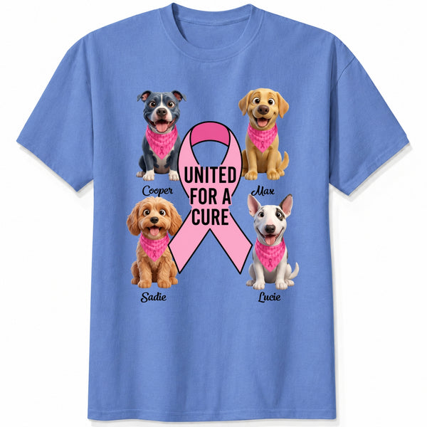 A blue short-sleeve crewneck t-shirt featuring a graphic print of dogs wearing pink bandanas around a large pink ribbon with the text 'UNITED FOR A CURE'.