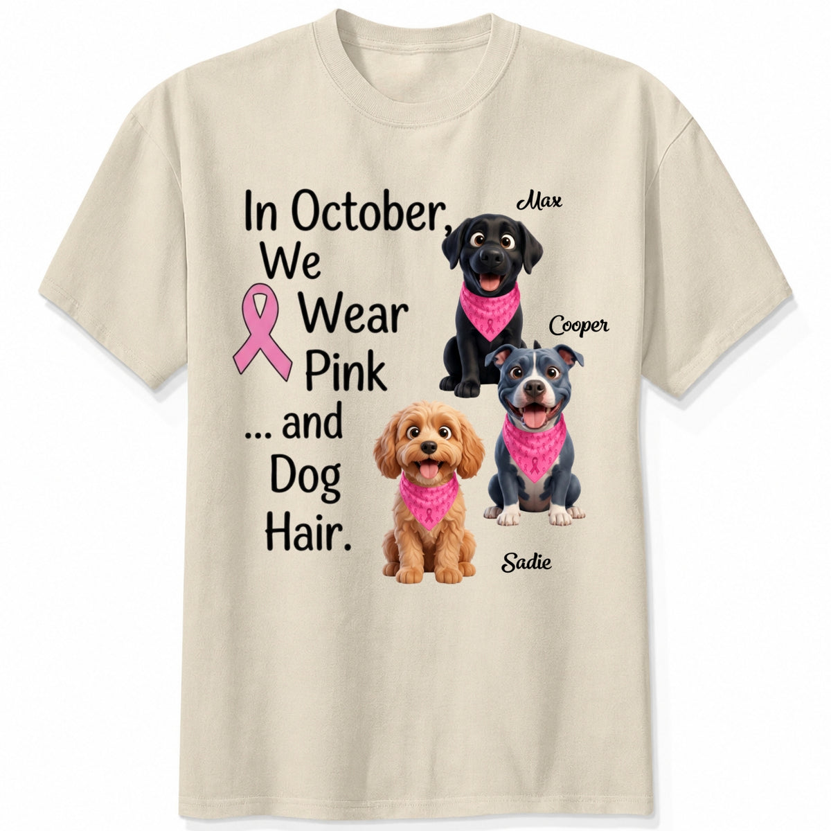 A sand short-sleeve crewneck t-shirt featuring a graphic print with three dogs wearing pink bandanas and the text 'In October, We Wear Pink and Dog Hair.'