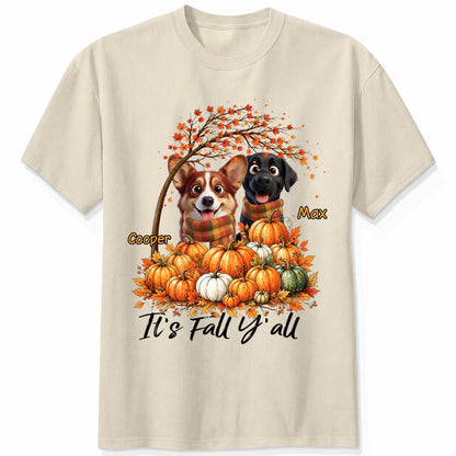 A sand short-sleeve crewneck t-shirt featuring a custom autumn graphic of custom dogs sitting on a pile of pumpkins under an orange tree, with the text 'It's Fall Y'all' and custom dog's names