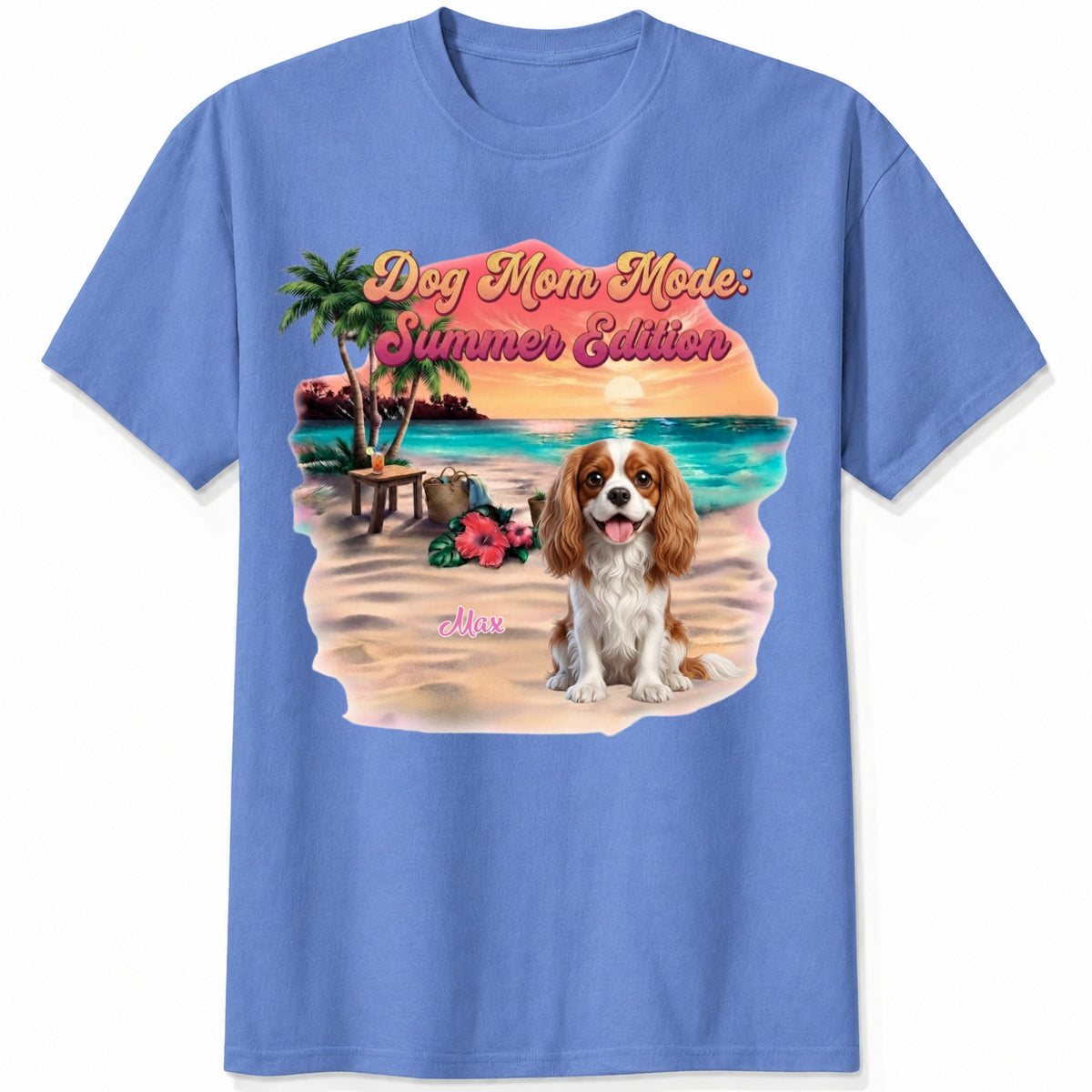 A blue short-sleeve crewneck t-shirt featuring a colorful graphic print of a dog on a beach with the text 'Dog Mom Mode: Summer Edition'. Personalized with a wide variety of dog breeds