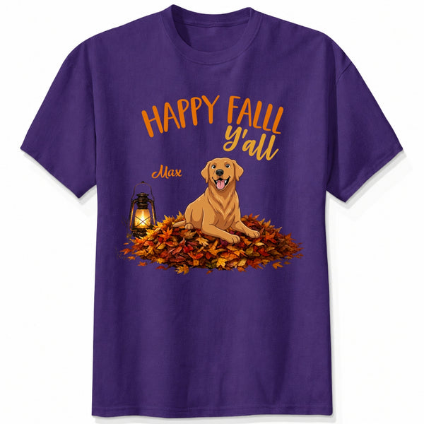 A purple short-sleeve crewneck t-shirt featuring a 'Happy Fall Y'all' graphic with custom dogs sitting on a pile of autumn leaves next to a glowing lantern.