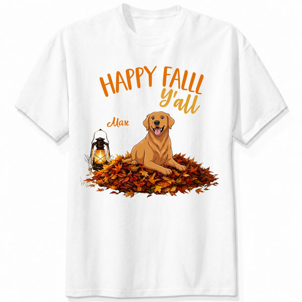 A white short-sleeve crewneck t-shirt featuring a 'Happy Fall Y'all' graphic with custom dogs sitting on a pile of autumn leaves next to a glowing lantern.