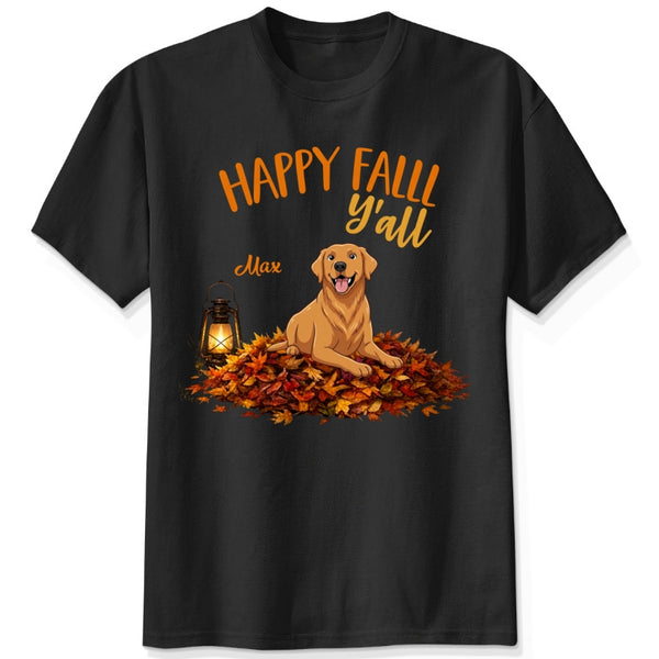 A black short-sleeve crewneck t-shirt featuring a 'Happy Fall Y'all' graphic with custom dogs sitting on a pile of autumn leaves next to a glowing lantern.