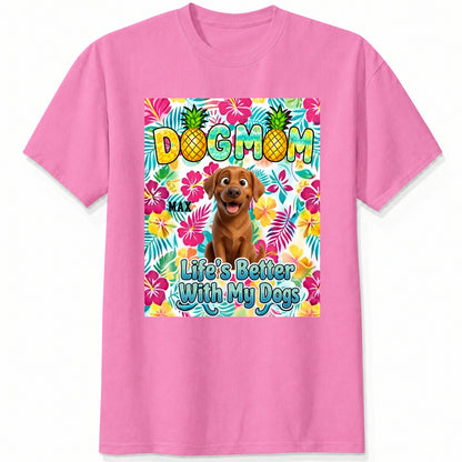 A pink custom dogs short-sleeve t-shirt featuring a colorful front graphic with the text 'DOG MOM' and 'Life's Better With My Dogs' alongside a cartoon dog and tropical floral background.