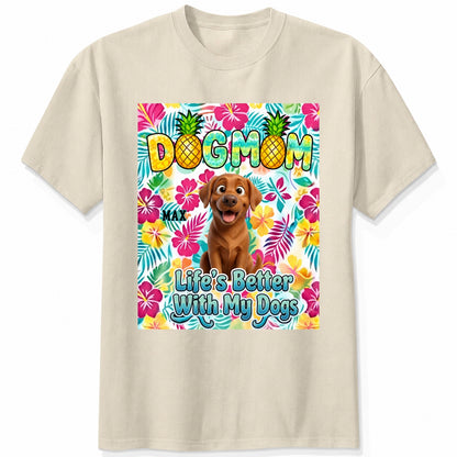 A sand custom dogs short-sleeve t-shirt featuring a colorful front graphic with the text 'DOG MOM' and 'Life's Better With My Dogs' alongside a cartoon dog and tropical floral background.