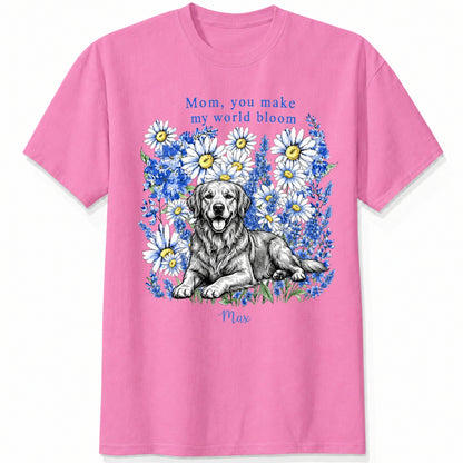 A pink gray custom dogs t-shirt featuring a graphic print of a golden retriever dog surrounded by blue flowers, with the text 'Mom, you make my world bloom' and dog's name written below.