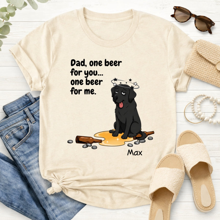 A cream-colored graphic t-shirt styled in a flat lay with blue jeans, beige slides...on a white wood background. The t-shirt features a custom cartoon dog wearing a halo and a beer glass, with the text 'Dad, one beer for you.... one beer for me'