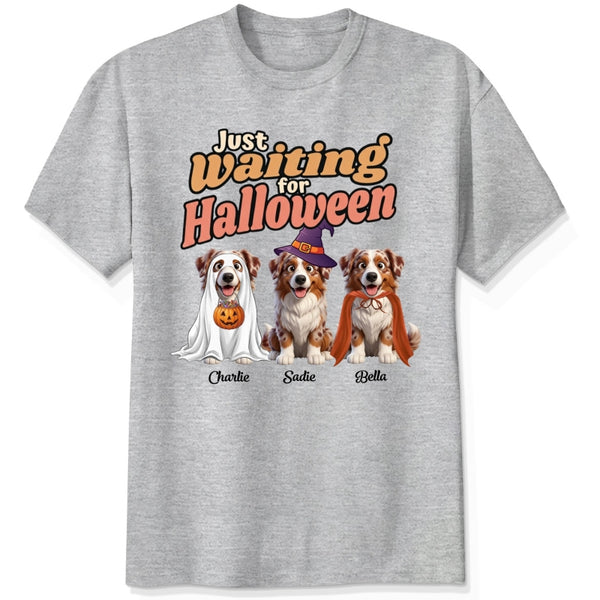 A ash grey short-sleeve crewneck t-shirt featuring dogs dressed in costumes and the text 'Just Waiting for Halloween'.